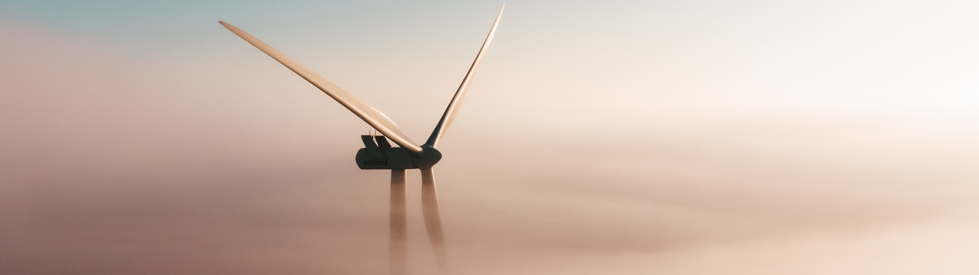 Wind turbine above clouds representing HVAC and energy sector