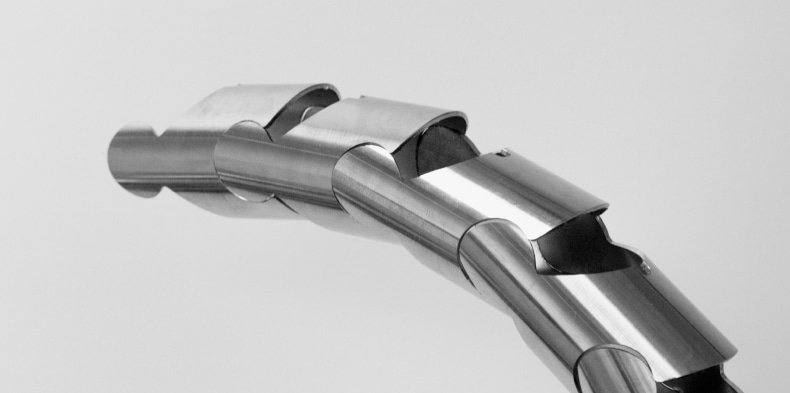 Laser-cut metal tube with interlocking segments forming a flexible curve