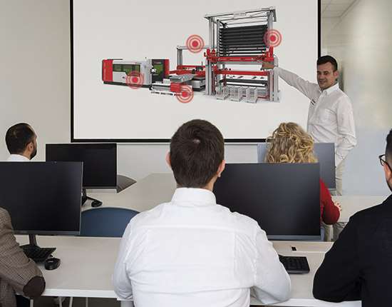 Instructor presenting TCI laser automation diagram in training room