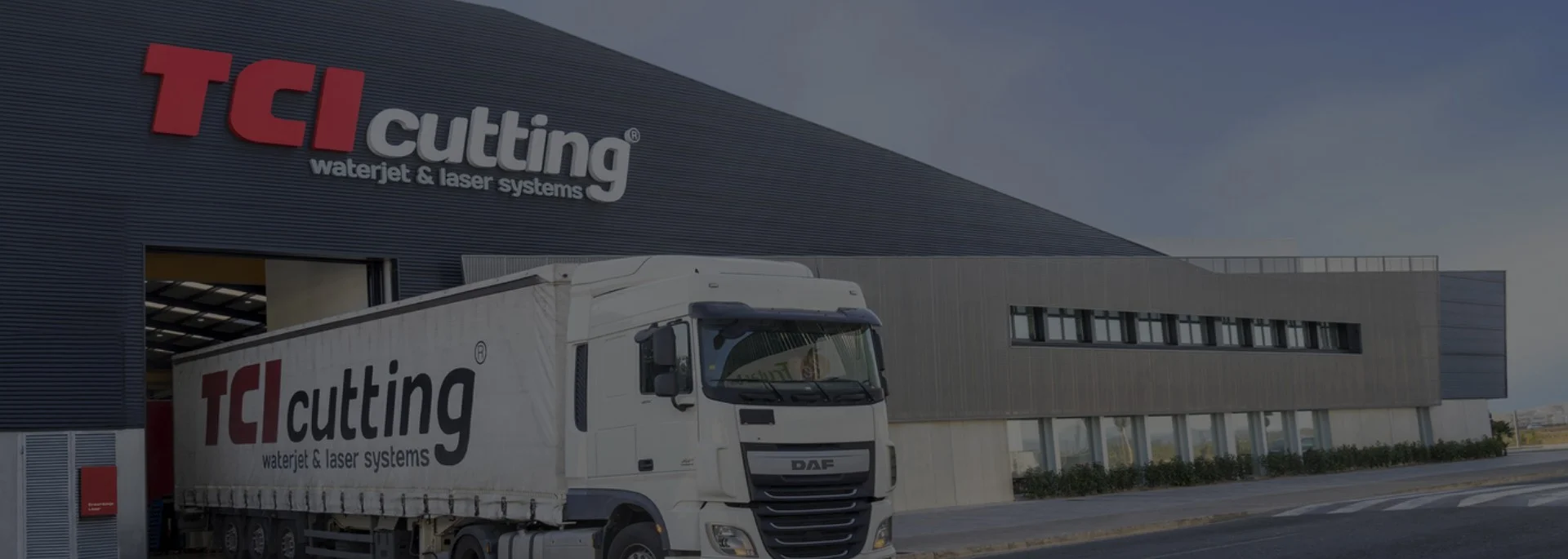 TCI Cutting factory loading bay with branded truck and waterjet laser systems logo